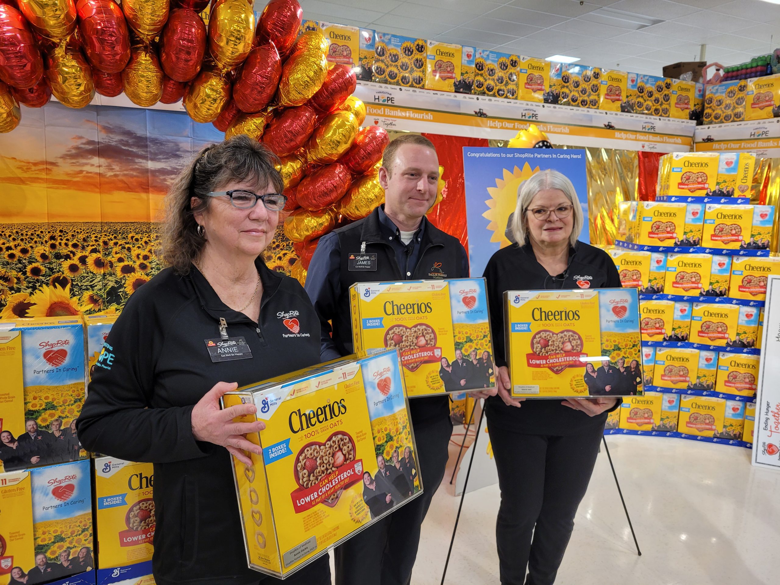 Shoprite employees holding Cheerios boxes