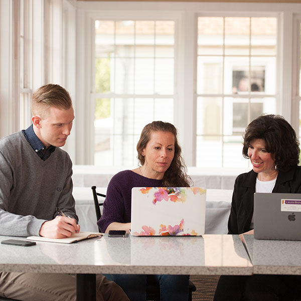 Ben, Lauren and Sheri work on a social media plan for a client Ben, LauBen, Lauren and Sheri work on a social media plan for a clientren and Sheri work on a social media plan for a client.)