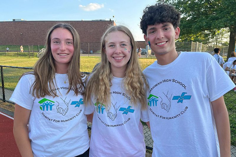 – Members of the MHS Habitat for Humanity Club pose for a photo on the High School track at the volleyball tournament fundraiser.