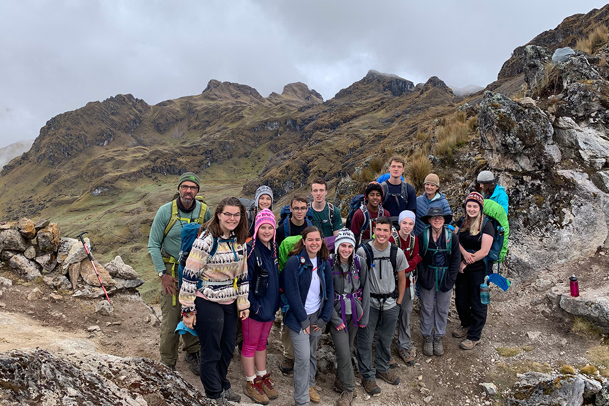 Students gathered on a Peruvian mountainside
