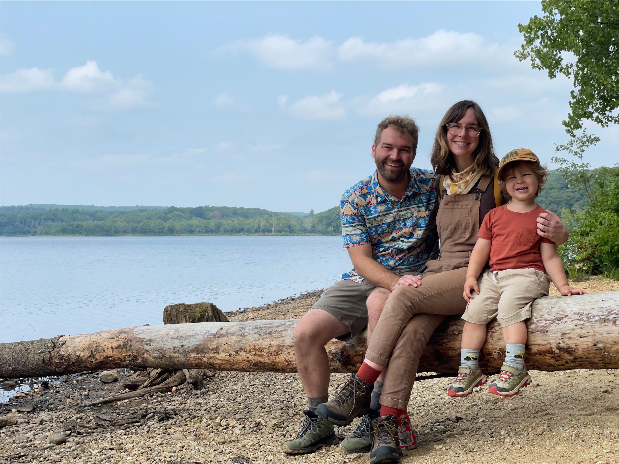 Krys Rossner and her family sit on a branch by the lake